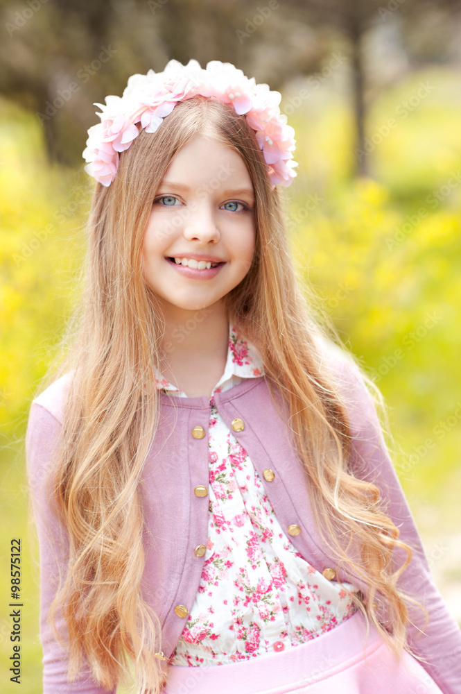 Smiling blonde teen girl 12-14 year old wearing pink stylish dress and  floral hairband outdoors. Looking at camera. Posing over green nature  background. Teenager hood. Stock Photo | Adobe Stock