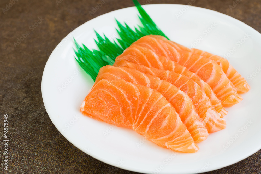 Sliced raw salmon on white plate Sliced raw salmon on white plate