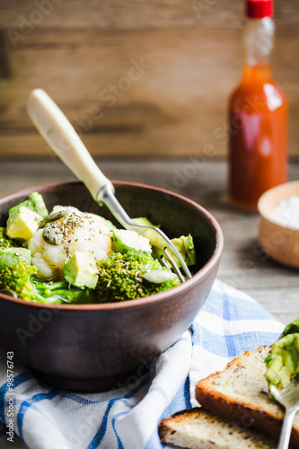 healthy vegetable salad with broccoli, cauliflower, avocados, pu