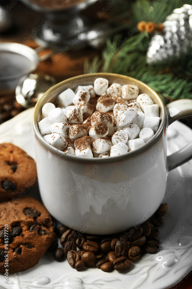 Mug of hot chocolate with marshmallows, fir tree branch on wooden background Mug of hot chocolate with marshmallows, fir tree branch on wooden background