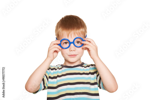 Happy little boy wearing glasses.