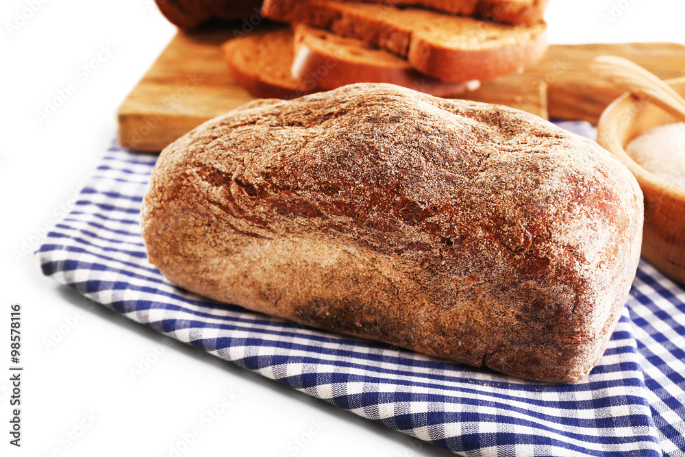 Naklejka premium Sliced bread with ears and flour on napkin isolated on white
