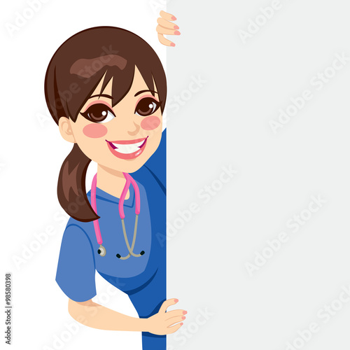 Cute happy young professional nurse peeking out of a blank billboard