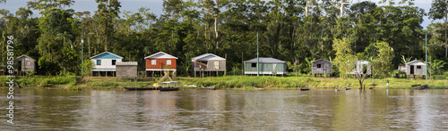 Wooden house on stilts along the Amazon river and rain forest, B
