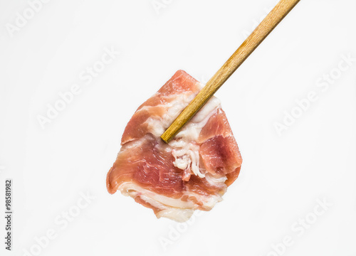 Chopsticks holding pork