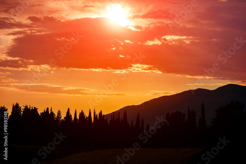 Orange Sun Setting Behind the Mountains © kotina