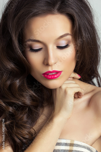 Portrait of young pretty woman wearing bright pink lipstick