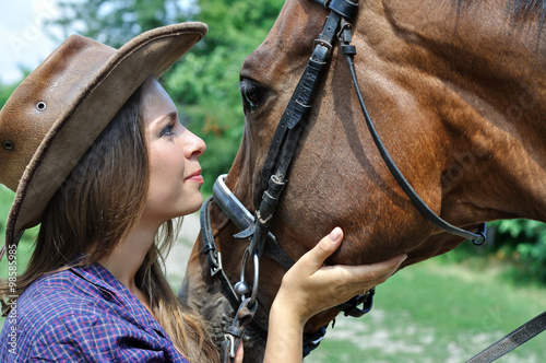 portrait of young cowgirl and horse