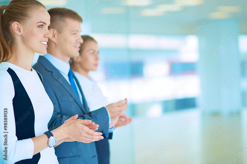 Smiling business people applauding a good presentation in the office Smiling business people applauding a good presentation in the office