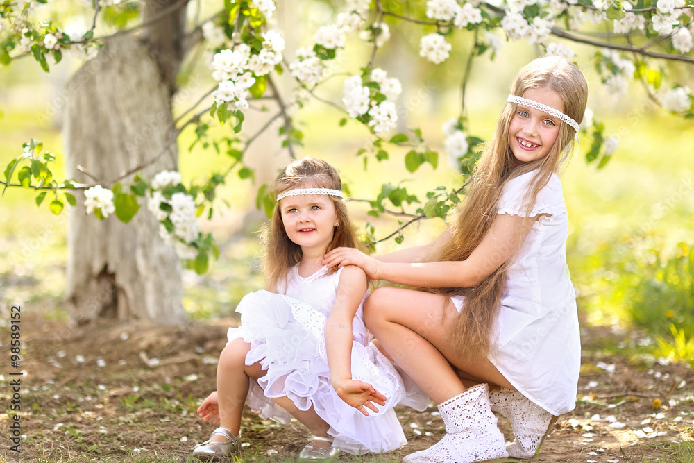portrait of two girls of girlfriends on a summer nature