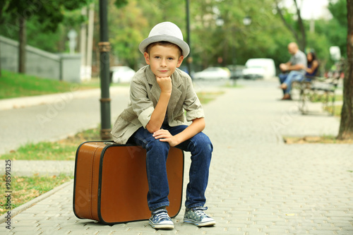 Little boy with suitcase in...