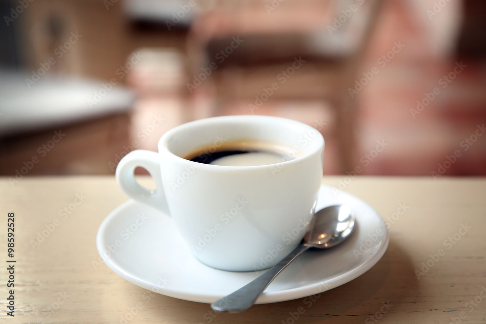 Cup of tasty coffee with spoon in cafe Cup of tasty coffee with spoon in cafe
