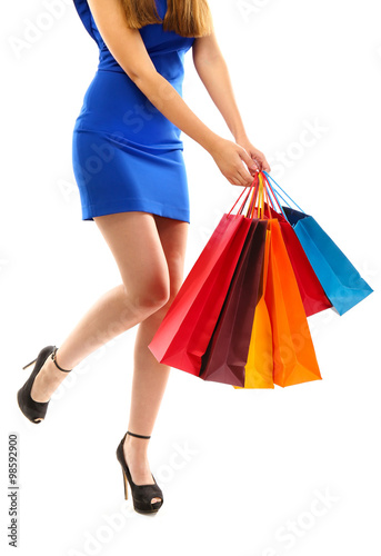 Young pretty woman with shopping packages isolated on white © Africa Studio