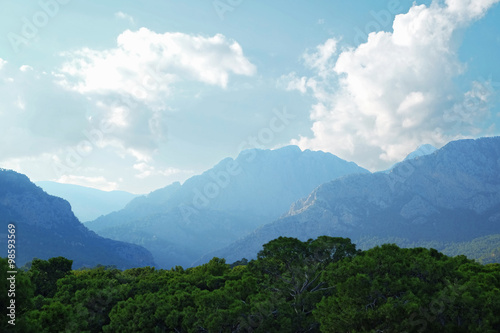 Blue sky with clouds and mountains peak