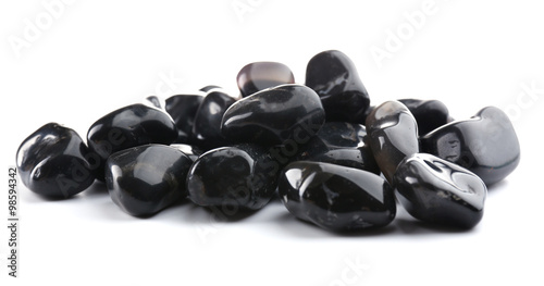 Black onyx pile isolated on white background photo