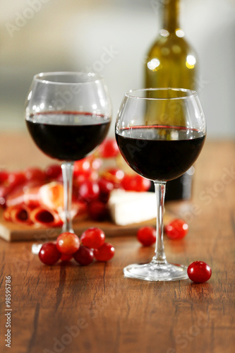 Two wineglasses with grape on the table