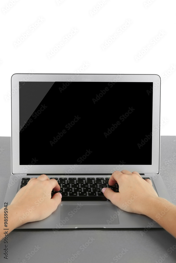 Fototapeta premium Female hands working on laptop, on light background
