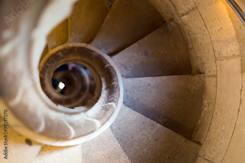 Close up view at narrow stone spiral stairway photo