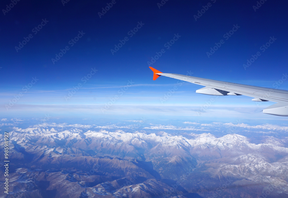 Looking though plane window to the Alps valley Looking though plane window to the Alps valley
