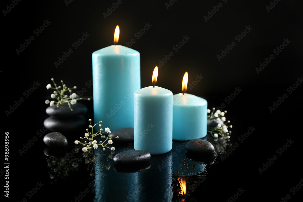 Spa composition of blue candles, flowers and stones on black background  Stock Photo | Adobe Stock
