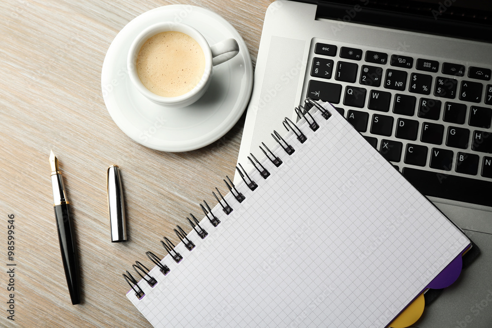 Empty notebook on laptop keyboard, on light background Empty notebook on laptop keyboard, on light background