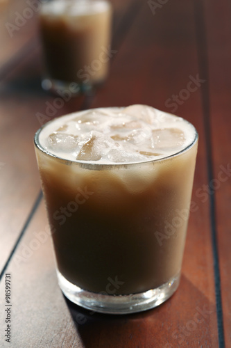 Cups of ice coffee on wooden table