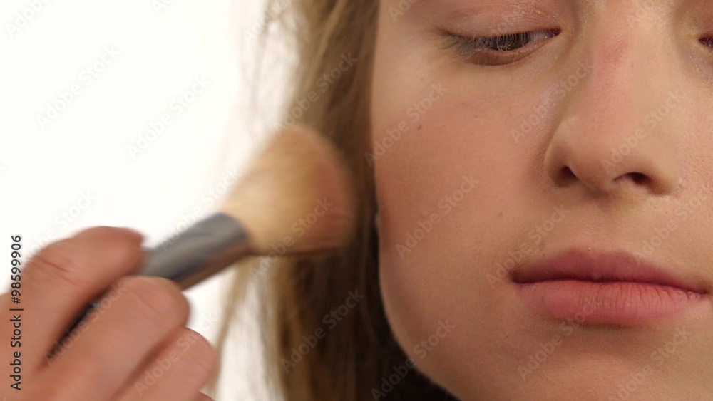 Makeup artist applying shimmer powder on beauty woman face. close up. Slow motion Makeup artist applying shimmer powder on beauty woman face. close up. Slow motion