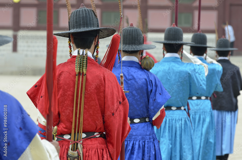 Row of armed guards in ancient traditional soldier uniforms in the old royal residence, Seoul, South Korea..