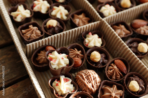 Different chocolate candies in paper box, close up