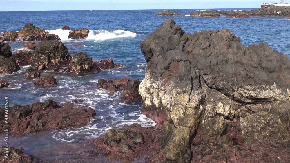 Ocean waves crashing on coastal brown rocks Ocean waves crashing on coastal brown rocks