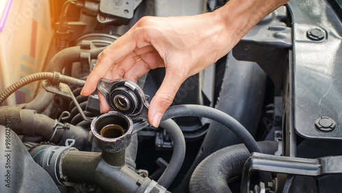 Open cap of cooling system  by hand, maintenance car by itsalf