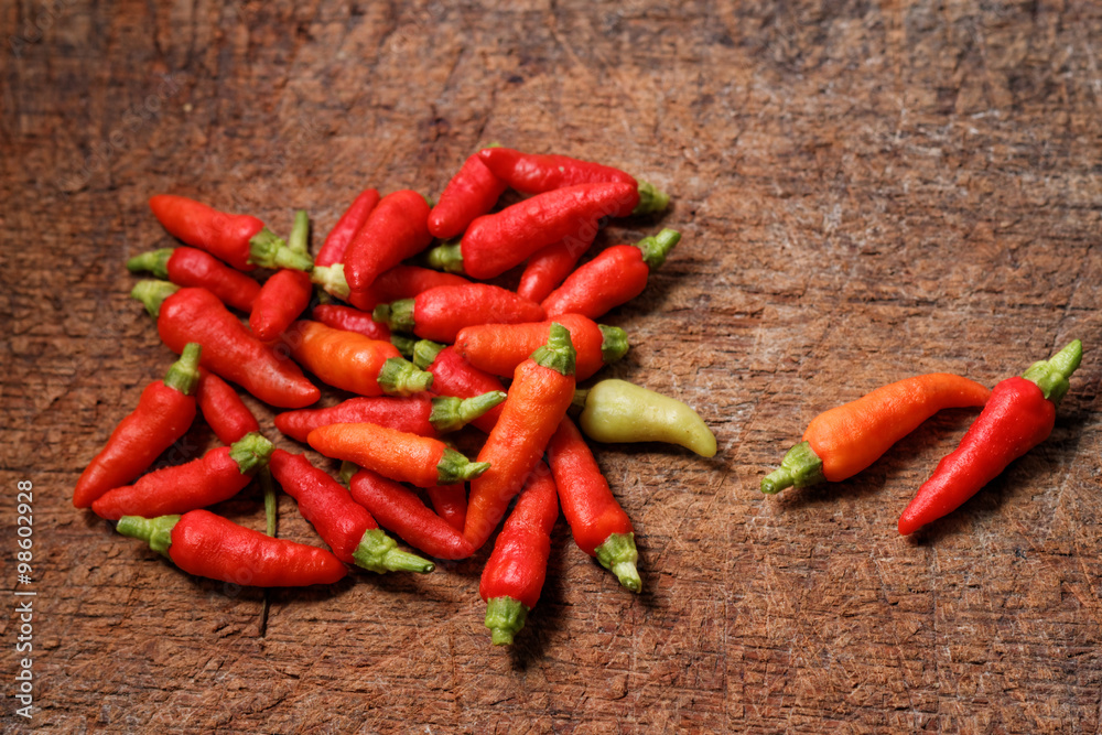Red chili pepper on old wooden chopping board Red chili pepper on old wooden chopping board