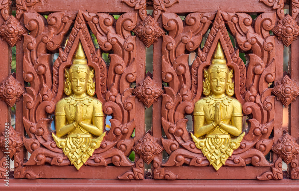 Row of Buddha statues on Buddhist temple wall