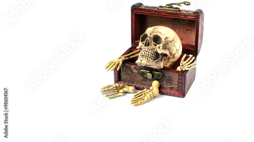 skull and bone in vintage wooden box on white background © supitstockphoto