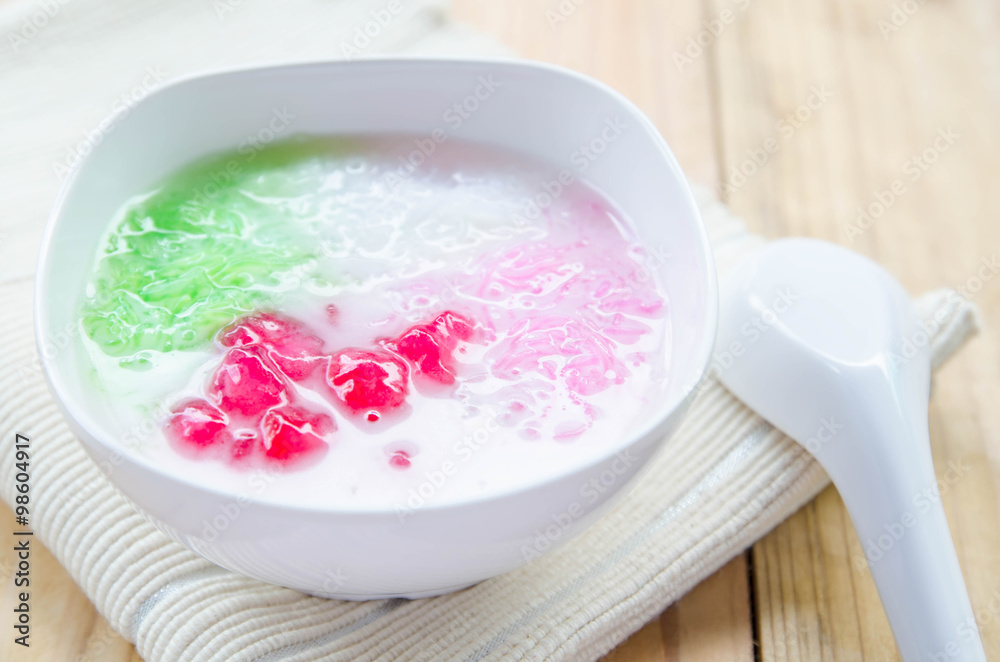 Tub Tim Krob ,Stuffed Water Chestnut in Syrup and Coconut Milk on wood table thailand dessert. Tub Tim Krob ,Stuffed Water Chestnut in Syrup and Coconut Milk on wood table thailand dessert.