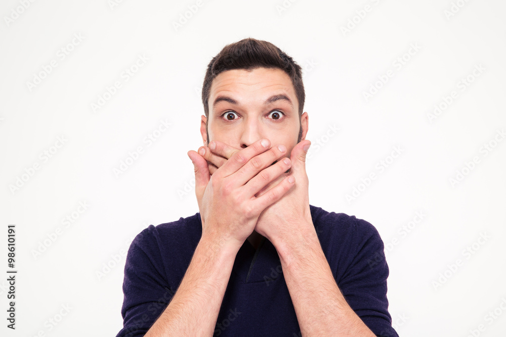 Shocked stunned young man covered mouth by hands Shocked stunned young man covered mouth by hands