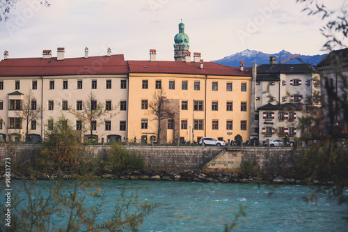 Beautiful super wide-angle aerial view of Innsbruck, Austria with skyline, Alps mountains and scenery beyond the city, and Inn river 