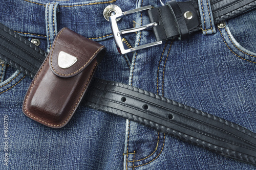 Blue jeans with leather belt and knife case