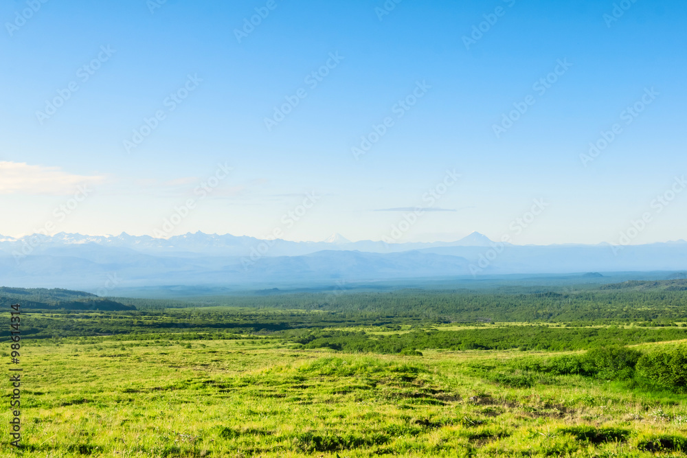 Meadows, hills and mountains, sunny day in the vast Kamchatka