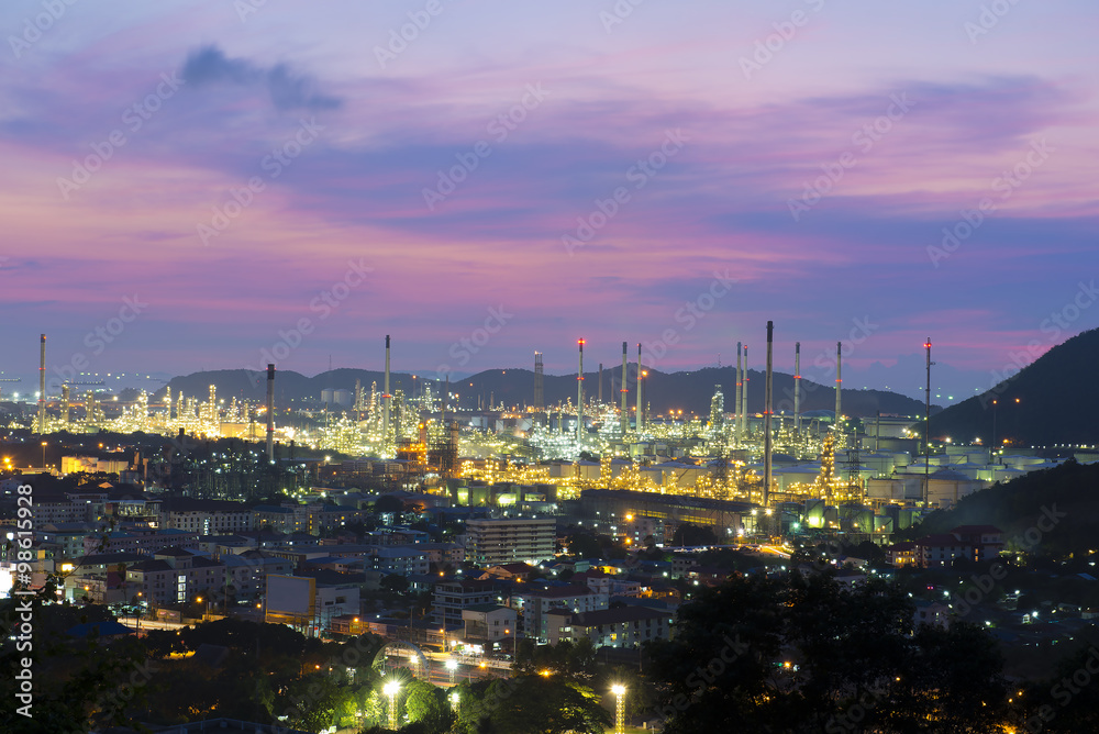 Oil refinery among the city at twilight. Oil refinery among the city at twilight.