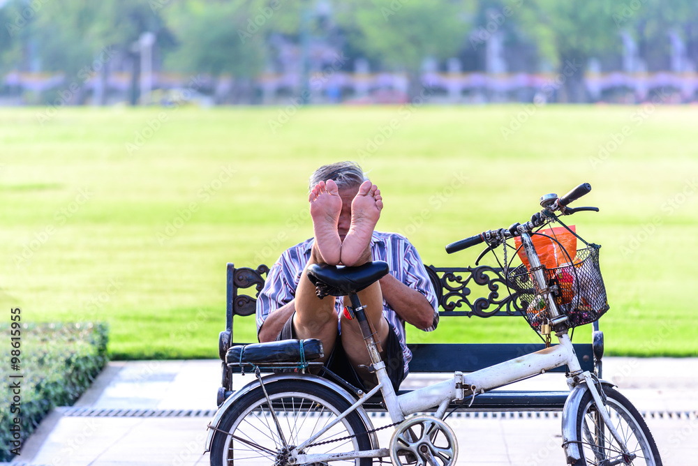 Obraz premium Man relaxing with bicycle in urban park.