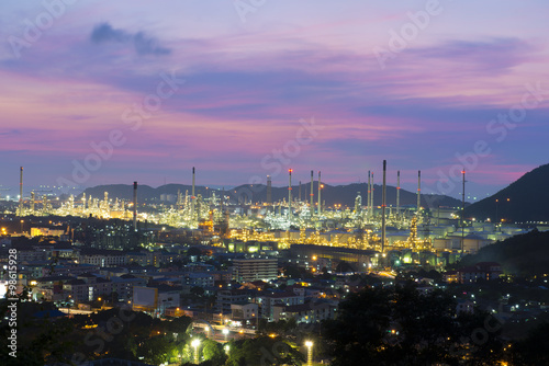 Oil refinery among the city at twilight.