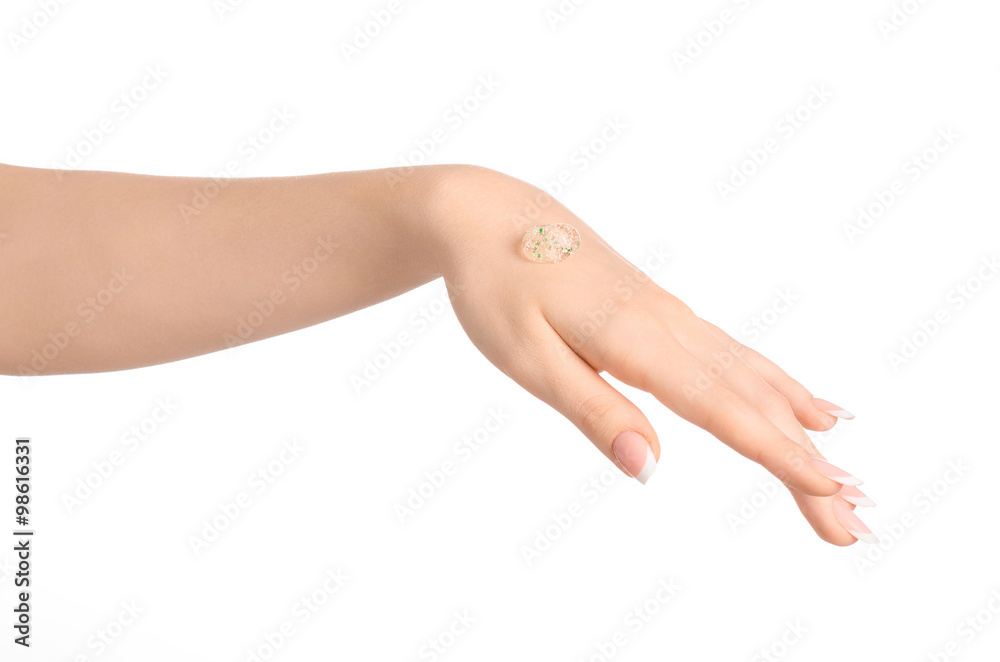 Health and body care theme: beautiful female hand with a transparent scrub cream on a white background isolated