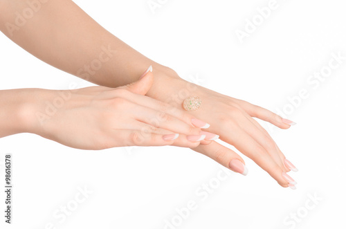 Health and body care theme  beautiful female hand with a transparent scrub cream on a white background isolated