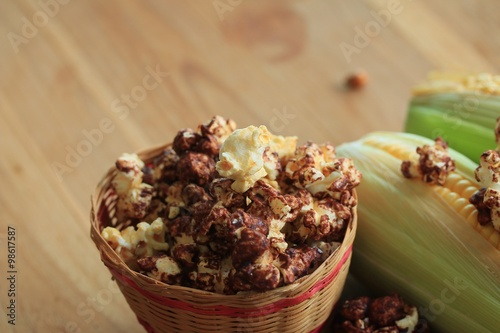 tasty popcorn and fresh corn photo