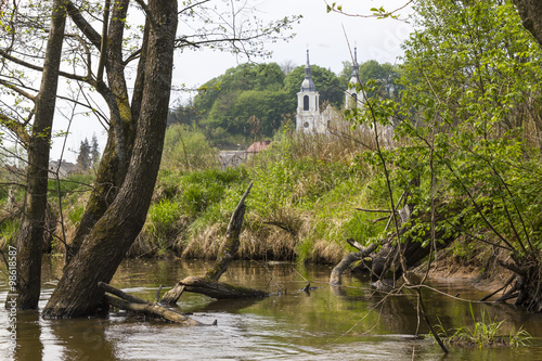 Obraz na plátně Church in the Baltow seen from the river Kamienna, Poland