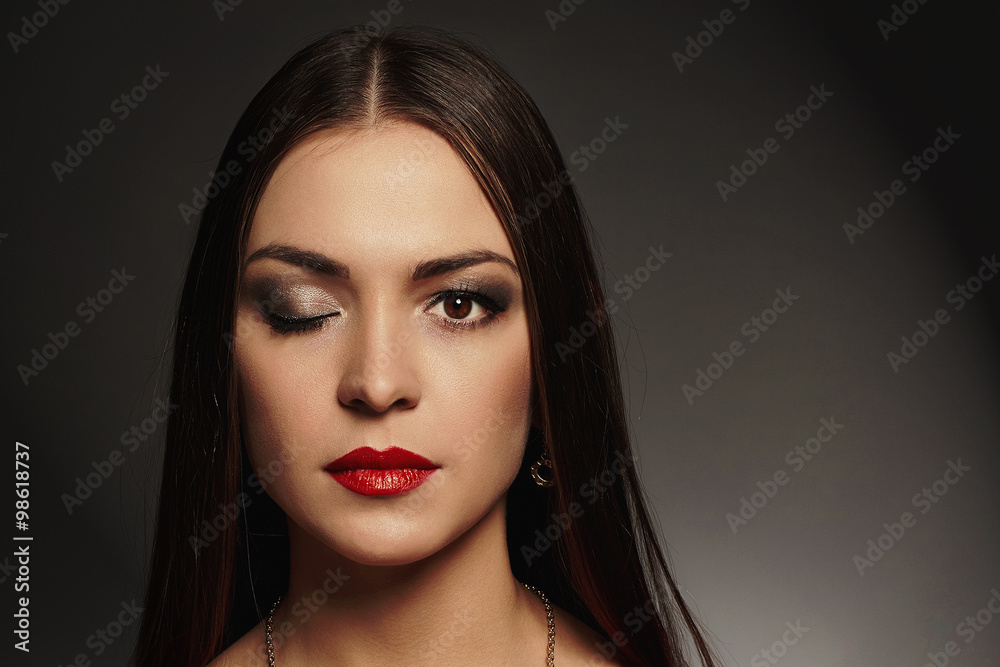 young beautiful woman with make-up.Beauty girl with closed one eye
