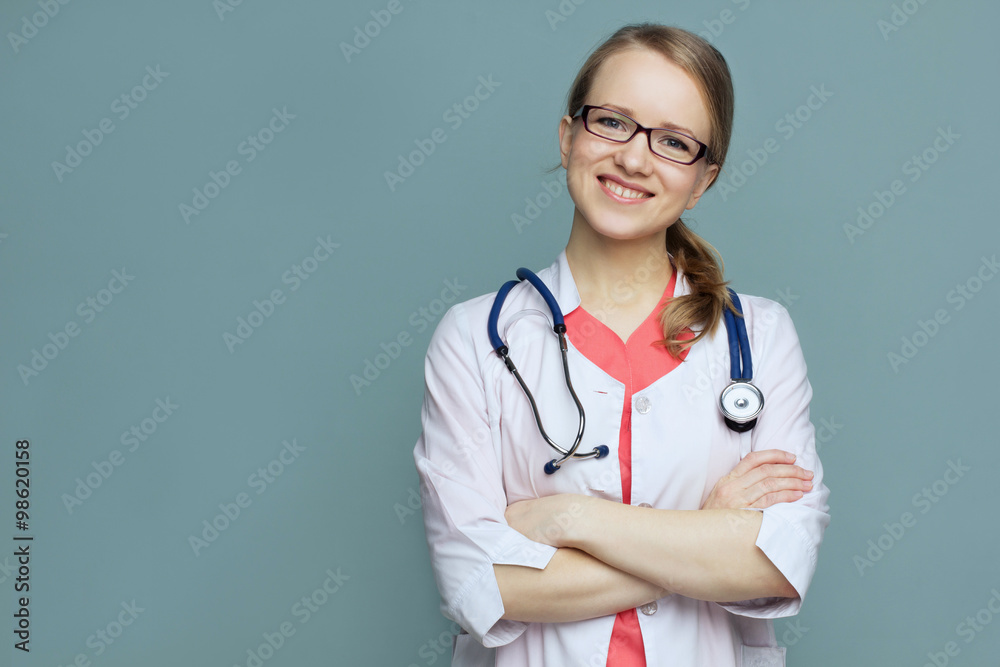 Medical doctor woman on a blue background smiling Medical doctor woman on a blue background smiling