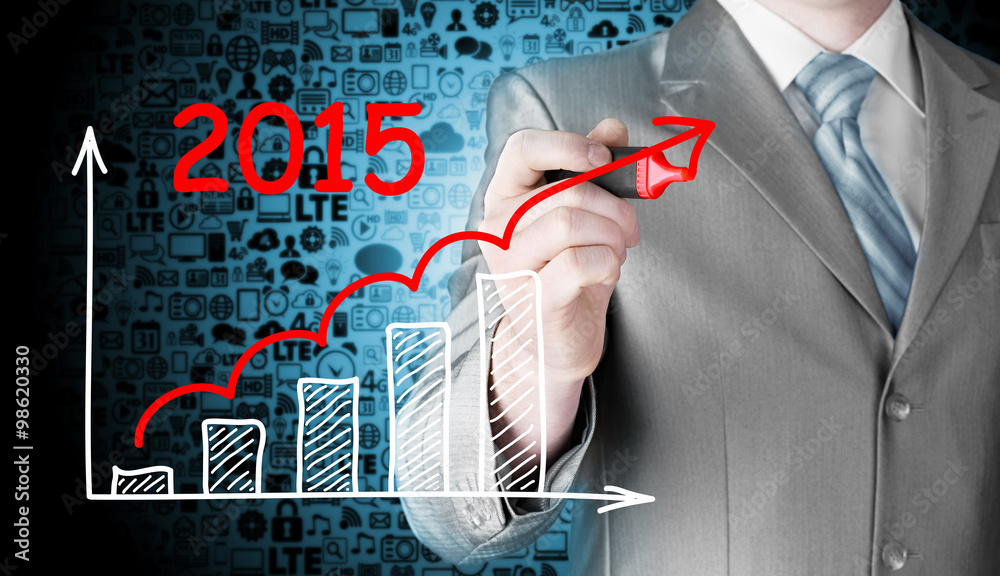 business man drawing growth graph for year 2015 business man drawing growth graph for year 2015