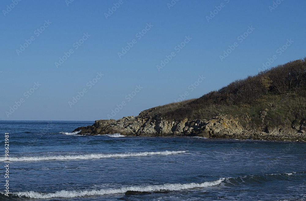 Acute rocky headland juts out into the sea